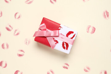Gift box with lipstick kiss marks on yellow background. Valentine's Day celebration