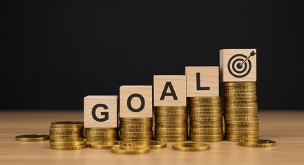 Financial growth concept: stacked coins and goal blocks leading to target