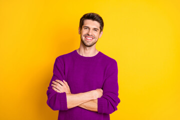 Portrait of charming man with his hands crossed wear red jumper isolated over yellow background