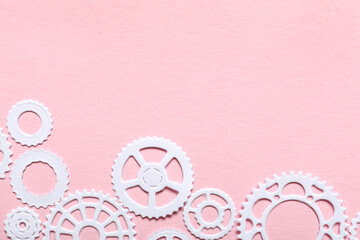 White paper gears on pink background