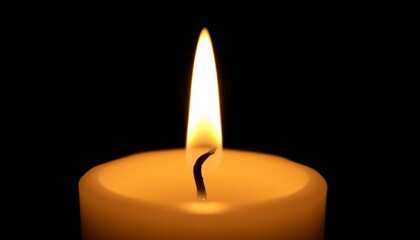 burning candle on black background