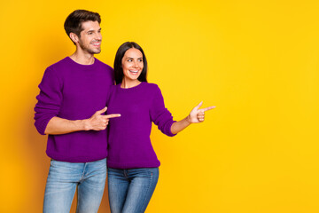 Profile side photo of two charming people point at copy space show promo wear red sweater denim jeans isolated over yellow background