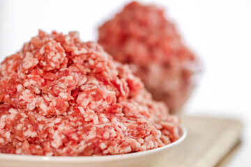 Mince.Ground Meat in a glass cup on a white background. Fresh meat bio product.Close-Up of Ground...