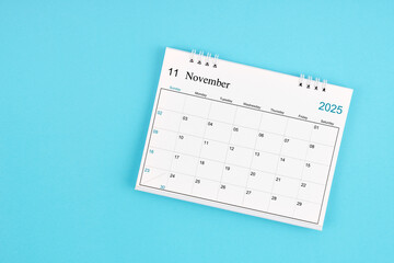 November 2025, Monthly desk calendar for 2025 year on blue background.