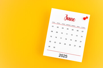 June 2025 calendar page with red push pin on yellow background.