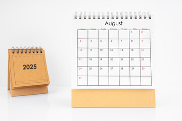 Monthly desk calendar August 2025 year on white table.