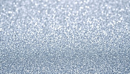 a close up of a silver glittered surface with a blurry background