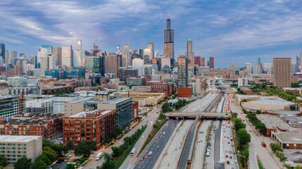 Chicago skyline at twilight, showing city streets, highways, and train tracks. Traffic flows through the urban landscape. West Loop, Chicago, Illinois, United States Of America © Zenstratus