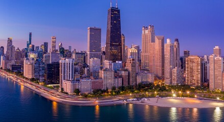 Fototapeta premium Chicago skyline at twilight, illuminated skyscrapers, traffic on lakefront road, tranquil beach. Downtown, Chicago, Illinois, United States Of America