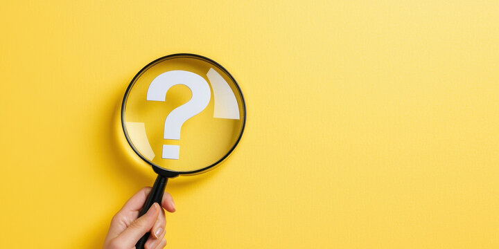 magnifying glass focusing on question mark against yellow background, symbolizing inquiry and curiosity