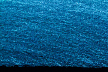 Vivid blue textured slab against a blue background. Modern abstract design.