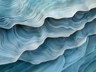 A close-up of layered blue textures, resembling waves or ice formations, showcasing intricate patterns and subtle color gradients.