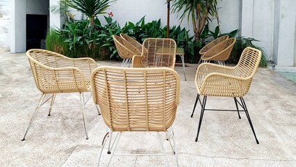 Obraz premium Classic Furniture Rattan Chairs and Table combined with glass and wooden rattan on the front terrace of the house