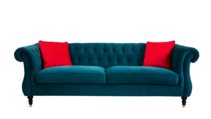A luxurious-looking sofa with a deep teal velvet upholstery on a transparent background. Two bright red pillows add a pop of color to the overall look
