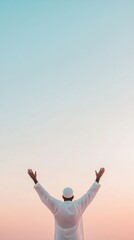 Tranquil Silhouette in Twilight Raised Arms Against a Pastel Sky