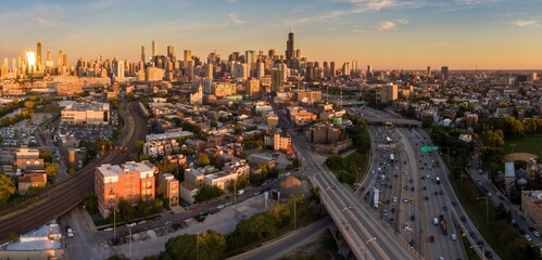 Chicago cityscape at sunset, showing the city's diverse architecture and busy highway traffic....