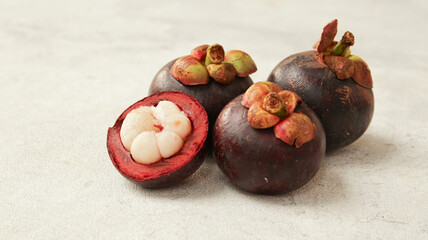Mangosteen with cut in half isolated on white background. Clipping path.