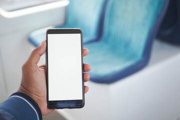 young man hand using smart phone with green screen inside of metro train