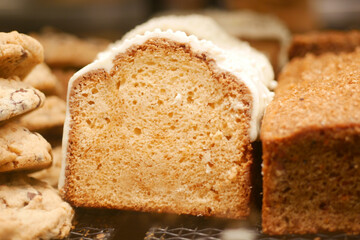 A Freshly Baked Loaf Cake Adorned with Icing and Accompanied by Cookies