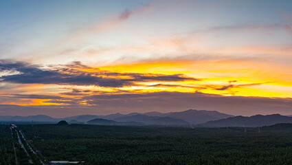 A serene twilight scene showcasing a vast valley with distant mountains and soft hues of blue and...