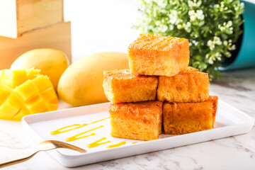 Mango Gold Brick west Toast Stack served in tray dish with fork isolated white marble background...