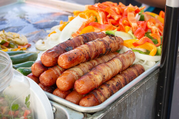 A view of a plate of bacon wrapped hot dogs.