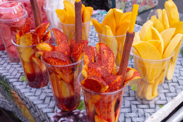 A view of a table of chopped fruit in cups.