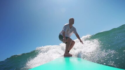 Man surfing on a sunny day in Mexico