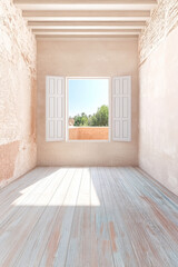 Empty room with bright sunlight and open windows overlooking green trees and a clear sky