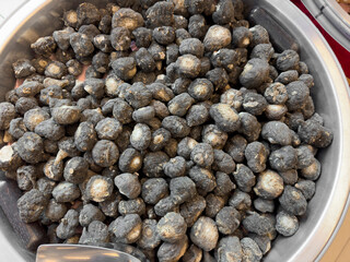 A top down view of a large bin of dried maca, on display at a local Chinese health food store.