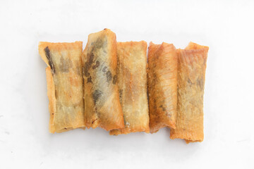 Top of view chocolate banana covered with thin skin made from flour, dessert from banana and chocolate, dessert isolated on white background