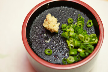 Chopped green onions and minced ginger