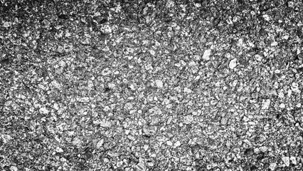 A close-up view of a textured asphalt surface, showcasing a rich pattern of small stones and aggregate