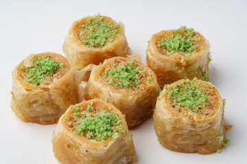 Mouthwatering traditional dessert featuring layers of pastry and nuts topped with green pistachio