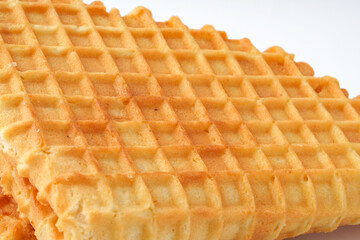 Crispy and golden waffles served on a clean white background ready to enjoy at breakfast or dessert
