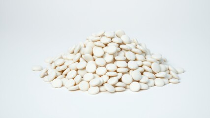 A sizable pile of small, off-white, disc-shaped objects rests on a plain white background.