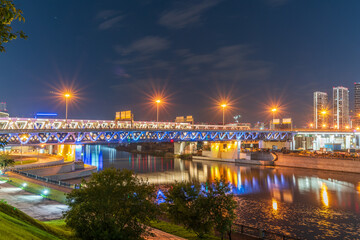 The scyscrapers of the Moscow City at night and the Dorogomilovsky bridge with illumination. Translation of text - street names: Krasnopresnenskaya, center, etc.