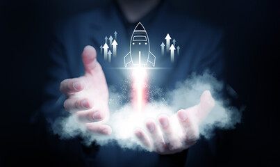 Startup business concept. Businessman launches a virtual rocket icon with up arrows for fast start up business. Starting the beginning of business journey and success.