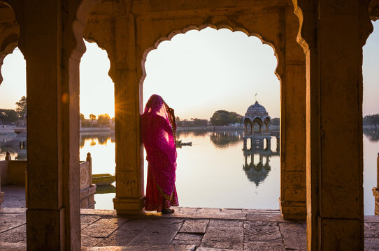 Indian woman with saree under an arch at Gadisar lake, Jaisalmer, India