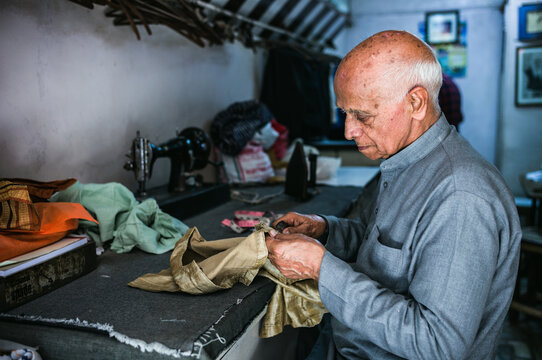 Indian tailor stitching clothes, Old Delhi, India