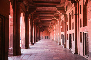 Arched sandstone corridor with columns at the mosque, India
