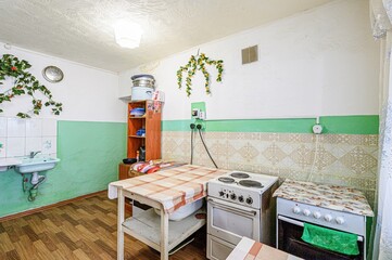 interior apartment kitchen and dining room, refectory area, cooking equipment, table furniture, stove