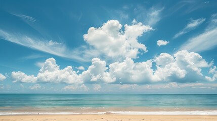 Fototapeta premium Pristine tropical beach under a vibrant blue sky with fluffy white clouds, perfect for summer vacations and showcasing a serene natural environment