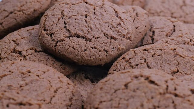Close up view of a group of cocoa-flavored biscuits. Slider shot. Desserts, snacks, treats, sweets concepts. 4k