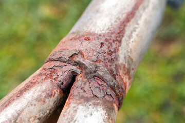 Rusty industrial pipe showing decay