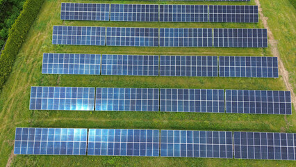 Aerial Shot of Solar Panels in a Green Field
