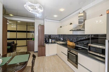 interior apartment kitchen and dining room, refectory area, cooking equipment, table furniture, stove