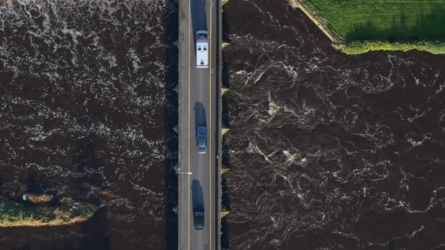A vehicle crossing a bridge over the boyne river in slane, ireland at daytime , aerial view