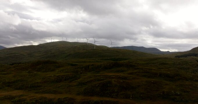 Sortland or Suort&aacute;, eolic wind turbines, landscape, green fields, countryside, cloudy day, Northern Norway in Scandinavia. Aerial drone panoramic view
