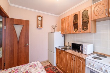 interior apartment kitchen and dining room, refectory area, cooking equipment, table furniture, stove